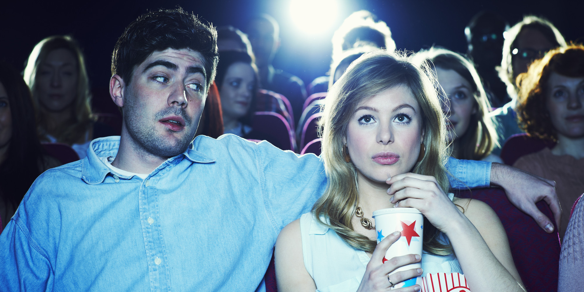 couple enjoying a movie at the cinema